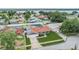 This single-Gathering home features a well-kept yard, red roof, and a white fence enclosing the backyard pool area at 10954 96Th St, Largo, FL 33773