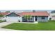 Charming single-Gathering home with a manicured lawn and updated exterior features a well-maintained front yard at 10954 96Th St, Largo, FL 33773