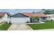 Well-maintained single-Gathering home with a manicured lawn and updated exterior features in a suburban neighborhood at 10954 96Th St, Largo, FL 33773