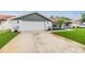 This renovated house features a well-manicured lawn and a two car garage with modern upgrades in a quiet neighborhood at 10954 96Th St, Largo, FL 33773
