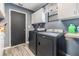 Laundry room featuring a modern washer and dryer set with upper cabinet storage at 10954 96Th St, Largo, FL 33773