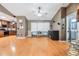 Spacious living room with hardwood floors, ceiling fan, and adjacent kitchen at 10954 96Th St, Largo, FL 33773