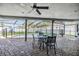 Covered patio with dining set overlooking a screened-in pool and fenced yard at 10954 96Th St, Largo, FL 33773