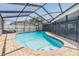 Sparkling screened-in pool with brick border and safety fence for peace of mind at 10954 96Th St, Largo, FL 33773