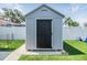 Exterior view of a matching utility shed on an artificial lawn at 10954 96Th St, Largo, FL 33773
