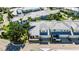 Aerial view of a colorful coastal home with a metal roof, lush landscaping, and inviting outdoor spaces at 110 Aberdeen Pond Dr, Apollo Beach, FL 33572