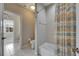 Bathroom featuring a toilet, bathtub with shower curtain, and a door to another room at 110 Aberdeen Pond Dr, Apollo Beach, FL 33572