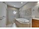 Modern bathroom featuring a mosaic tile wall accenting a soaking tub and glass shower at 110 Aberdeen Pond Dr, Apollo Beach, FL 33572