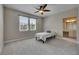 Bright bedroom featuring a small bed, a ceiling fan, two windows, and gray carpet at 110 Aberdeen Pond Dr, Apollo Beach, FL 33572