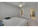 Bright bedroom featuring a large bed, a ceiling fan, a window view, and an open door to another room at 110 Aberdeen Pond Dr, Apollo Beach, FL 33572