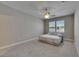 Bright bedroom featuring a large bed with drawers, a ceiling fan, and a window view at 110 Aberdeen Pond Dr, Apollo Beach, FL 33572