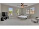 Well-lit bedroom with large windows, carpeted floors, and a ceiling fan at 110 Aberdeen Pond Dr, Apollo Beach, FL 33572