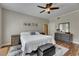 Relaxing bedroom featuring hardwood floors, a plush bed, ample natural light, and stylish decor, plus ample space and storage at 110 Aberdeen Pond Dr, Apollo Beach, FL 33572