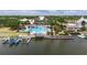 A large community pool and splash pad with waterslides are surrounded by palm trees and a long dock with boat slips at 110 Aberdeen Pond Dr, Apollo Beach, FL 33572