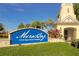 A sunny view of the community entrance sign surrounded by lush greenery and tropical plants, welcoming residents and visitors at 110 Aberdeen Pond Dr, Apollo Beach, FL 33572
