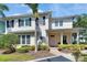 Inviting two-story home with a covered porch, lush landscaping, and a welcoming entrance at 110 Aberdeen Pond Dr, Apollo Beach, FL 33572