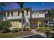 Charming two-story home with a welcoming front porch and meticulously landscaped yard. Brick path, palm trees, and fresh exterior paint at 110 Aberdeen Pond Dr, Apollo Beach, FL 33572