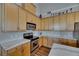 Kitchen featuring wood cabinets, stainless steel appliances, and marble countertops at 110 Aberdeen Pond Dr, Apollo Beach, FL 33572