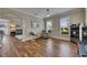 Elegant living space featuring gleaming hardwood floors, abundant natural light, and stylish furnishings with view into another room at 110 Aberdeen Pond Dr, Apollo Beach, FL 33572