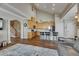 Well-lit living room featuring hardwood floors, stairs, and kitchen at 110 Aberdeen Pond Dr, Apollo Beach, FL 33572