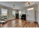 Inviting living room with hardwood floors, natural light and modern fixtures, complemented by a cozy chair at 110 Aberdeen Pond Dr, Apollo Beach, FL 33572