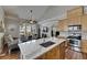 Open floor plan showcases a kitchen island, hardwood floors, and a vaulted ceiling at 110 Aberdeen Pond Dr, Apollo Beach, FL 33572