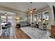 Comfortable living room with large windows and access to kitchen and dining areas at 110 Aberdeen Pond Dr, Apollo Beach, FL 33572