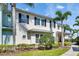 Beautifully landscaped side view highlighting the architectural details of this light and airy home with palm trees and fresh landscaping at 110 Aberdeen Pond Dr, Apollo Beach, FL 33572