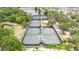 Aerial view of green tennis courts, lush landscaping, and a gazebo in the community at 110 Aberdeen Pond Dr, Apollo Beach, FL 33572