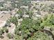 Aerial view of acreage, house, and waterways, with mature trees at 1141 Myrtle Rd, Valrico, FL 33596