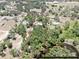 Expansive aerial view of a property featuring lush greenery, a private pond, and a home outlined in red at 1141 Myrtle Rd, Valrico, FL 33596