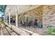 Covered back porch with brick flooring, ceiling fans, and outdoor seating to enjoy the outdoors at 1141 Myrtle Rd, Valrico, FL 33596