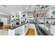 Elegant bar area featuring black countertops and extensive glass shelving for displaying glassware at 1141 Myrtle Rd, Valrico, FL 33596