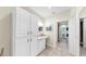 Bright bathroom featuring cream-colored countertops, white cabinets, tiled flooring, and bright lighting at 1141 Myrtle Rd, Valrico, FL 33596