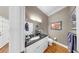 Stylish half-bathroom with granite countertop vanity, hardwood floors, and decorative artwork at 1141 Myrtle Rd, Valrico, FL 33596