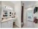 Bathroom featuring cream-colored countertops, white cabinets, tiled flooring, and a walk-in shower at 1141 Myrtle Rd, Valrico, FL 33596