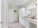 Bathroom featuring cream-colored countertops, white cabinets, tiled flooring, and bright lighting at 1141 Myrtle Rd, Valrico, FL 33596