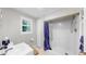 Bright bathroom features a shower with a blue curtain and a white sink at 1141 Myrtle Rd, Valrico, FL 33596
