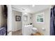 Bathroom with white vanity, toilet, mirror, and natural light from the window at 1141 Myrtle Rd, Valrico, FL 33596