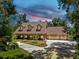 Stunning home with three dormers, mature trees, and a circular drive surrounded by landscaped garden beds at 1141 Myrtle Rd, Valrico, FL 33596