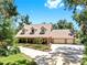 Inviting home exterior with a charming porch, a three-car garage, well-manicured landscaping, and a spacious driveway at 1141 Myrtle Rd, Valrico, FL 33596