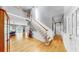 Spacious foyer with hardwood flooring, staircase and wainscoting leading to other rooms at 1141 Myrtle Rd, Valrico, FL 33596