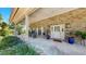 Spacious covered brick front porch with seating and a view of the beautifully landscaped yard at 1141 Myrtle Rd, Valrico, FL 33596
