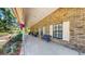 Welcoming front porch with bench, rocking chairs, and plants on a brick home at 1141 Myrtle Rd, Valrico, FL 33596