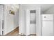 Hallway with laundry closet and full-size refrigerator at 1141 Myrtle Rd, Valrico, FL 33596