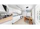 Bright kitchen featuring white cabinets, modern appliances, and a dining table near the window at 1141 Myrtle Rd, Valrico, FL 33596