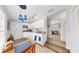 Bright kitchen featuring white cabinets, modern appliances, dining table, and an open doorway to the living space at 1141 Myrtle Rd, Valrico, FL 33596