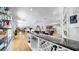 Open-concept area featuring a bar, hardwood floors, neutral paint, and plenty of natural light at 1141 Myrtle Rd, Valrico, FL 33596