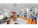 Open-concept living area boasting hardwood floors, a bar, and custom built-in shelving for decor at 1141 Myrtle Rd, Valrico, FL 33596