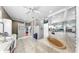 Luxury bathroom with a soaking tub, double sinks, white vanities, and a large mirror at 1141 Myrtle Rd, Valrico, FL 33596